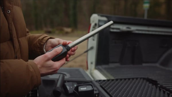 Close-up of someone putting together filming equipment with color grading applied.